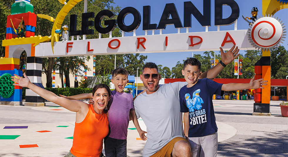 Family posing in front of legoland florida