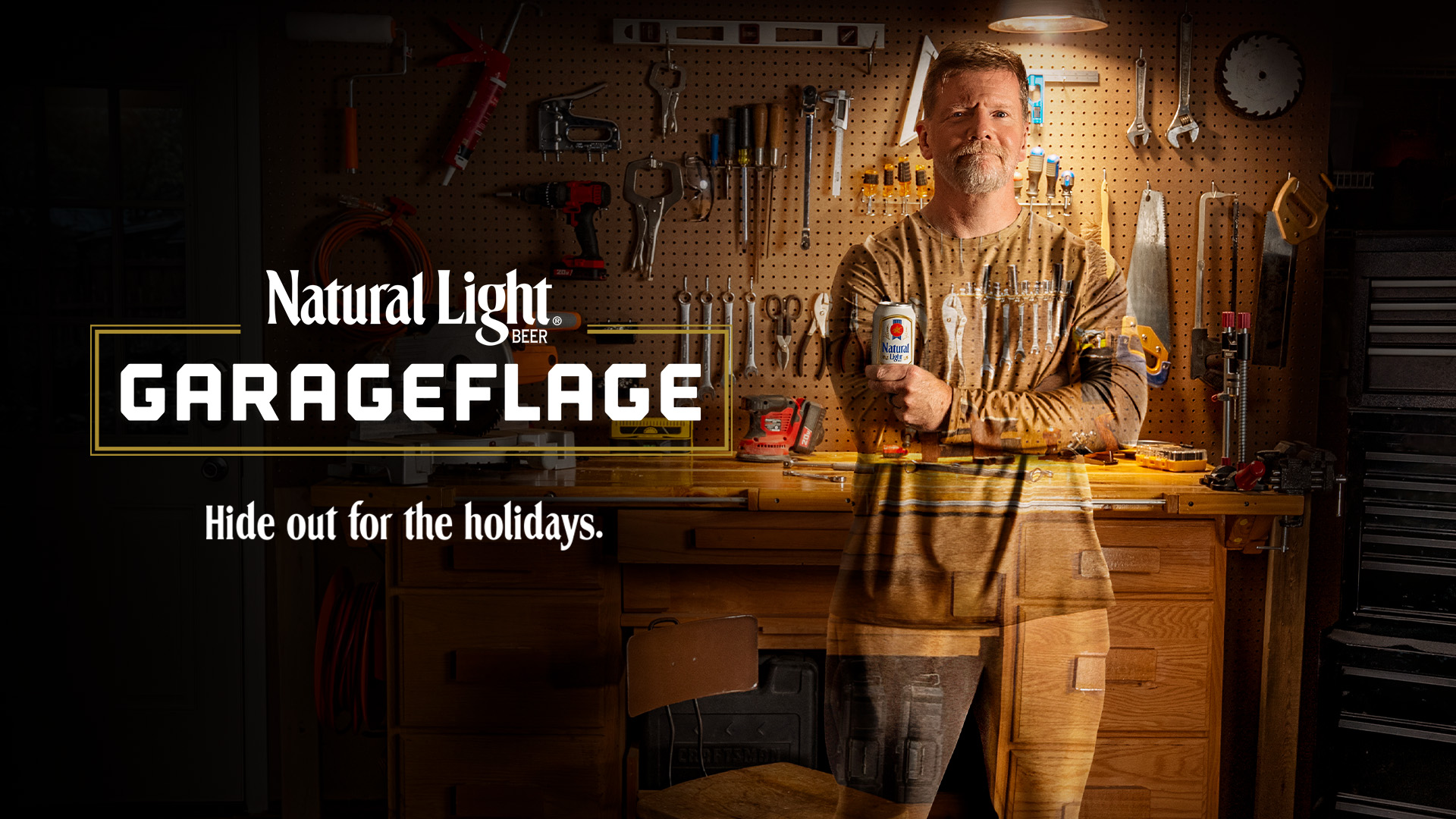 Man holding a busch light can camouflaged in garage parts.