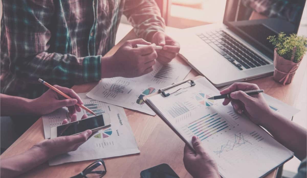 Office staff discussing about companies financial report