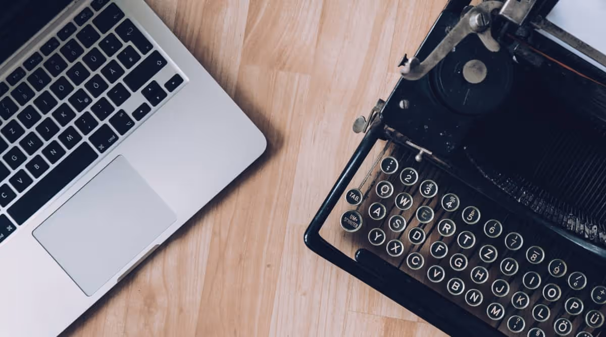 A Laptop And Typewriter On A Table - Blog - Autymate