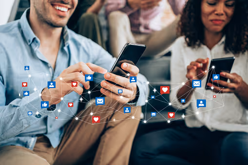 A group of people using their phones to access social media.