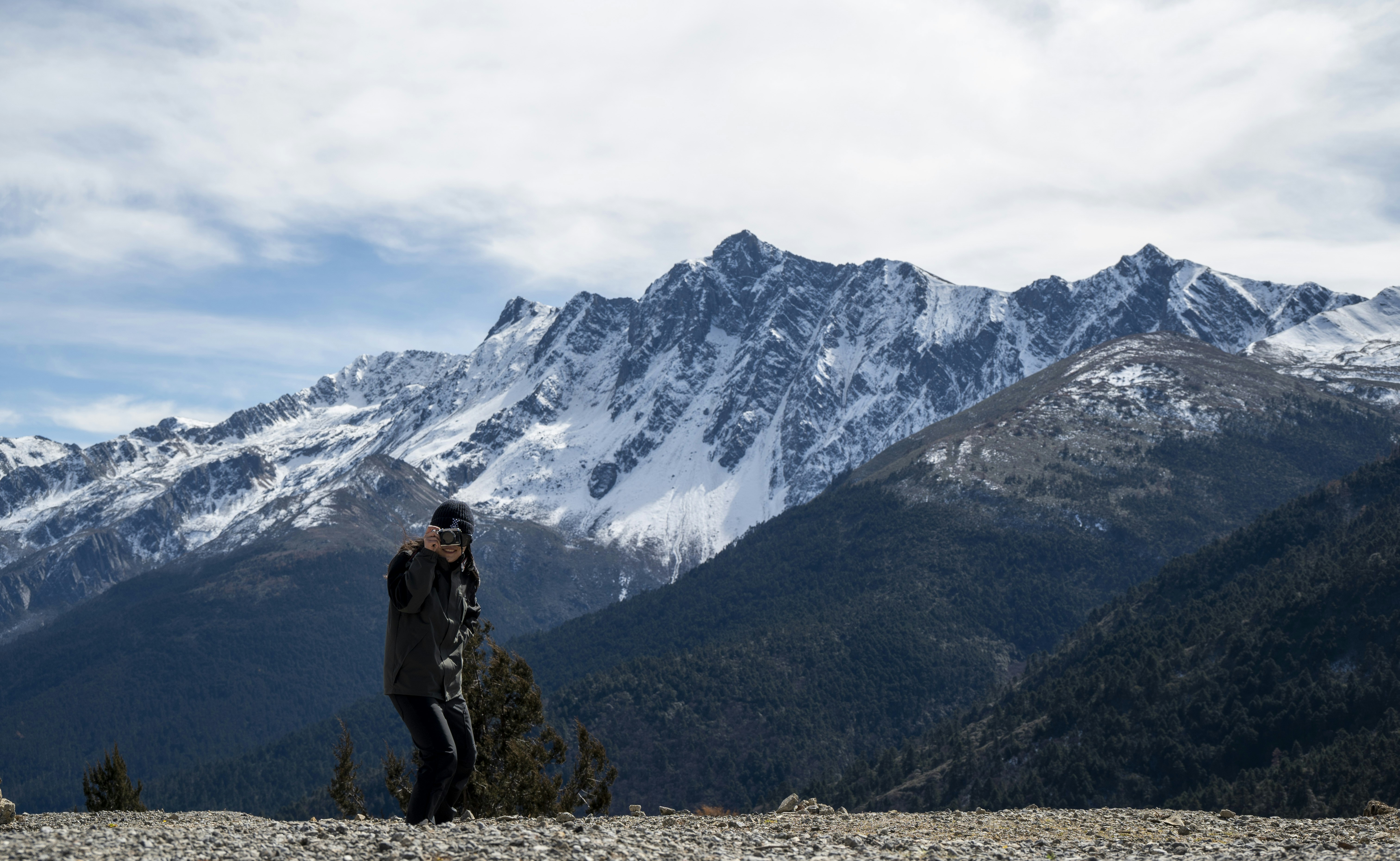 business owner looking at a mountain range, symbolizing future possibilities - business exit plan