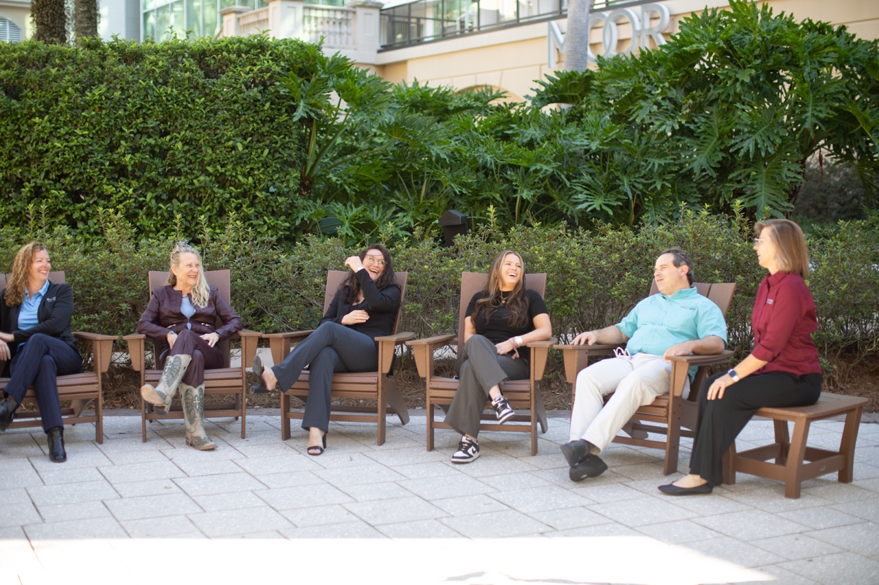 Team reunited chatting and laughing.