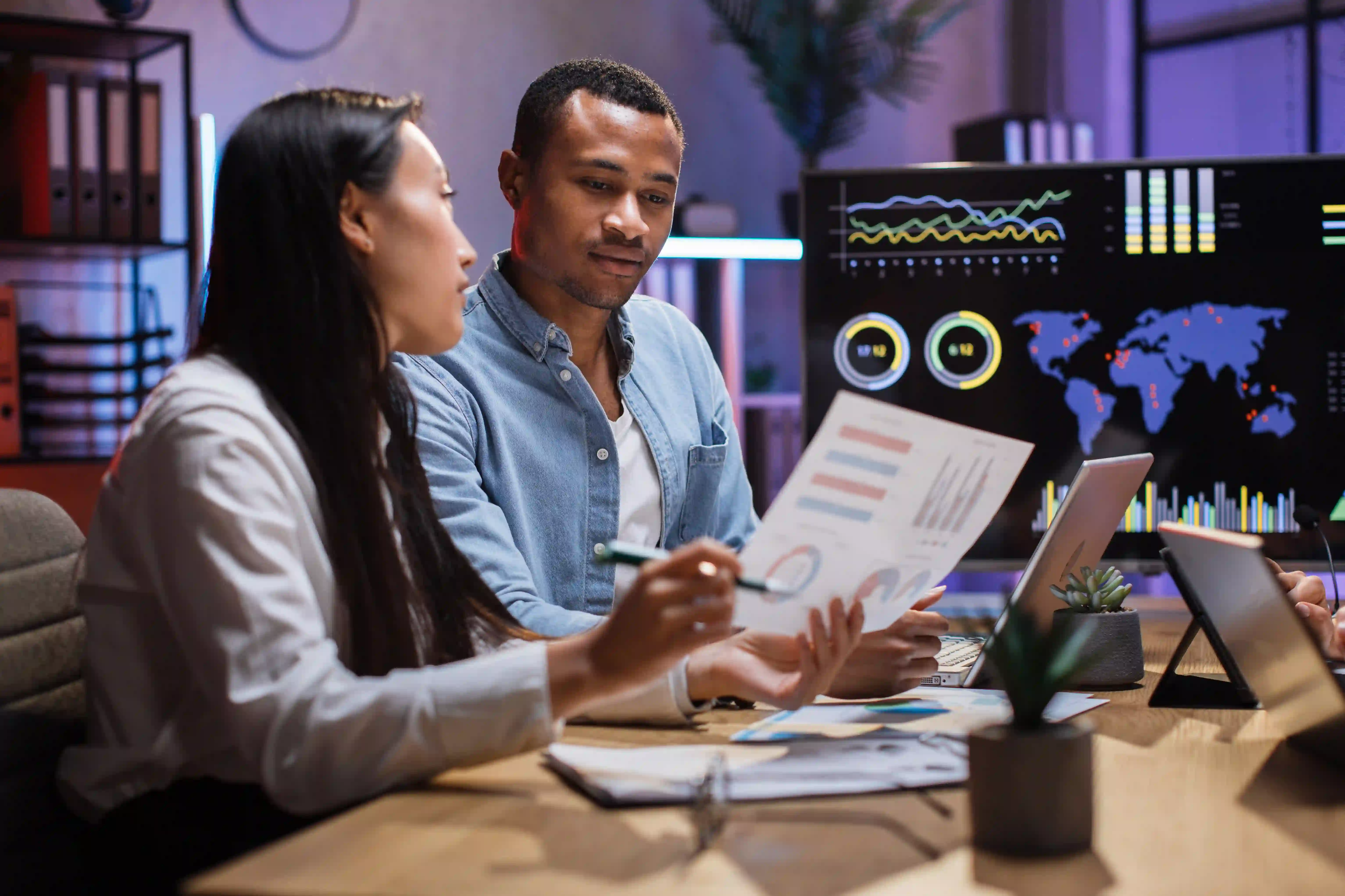 African man and asian woman having paperwork at office