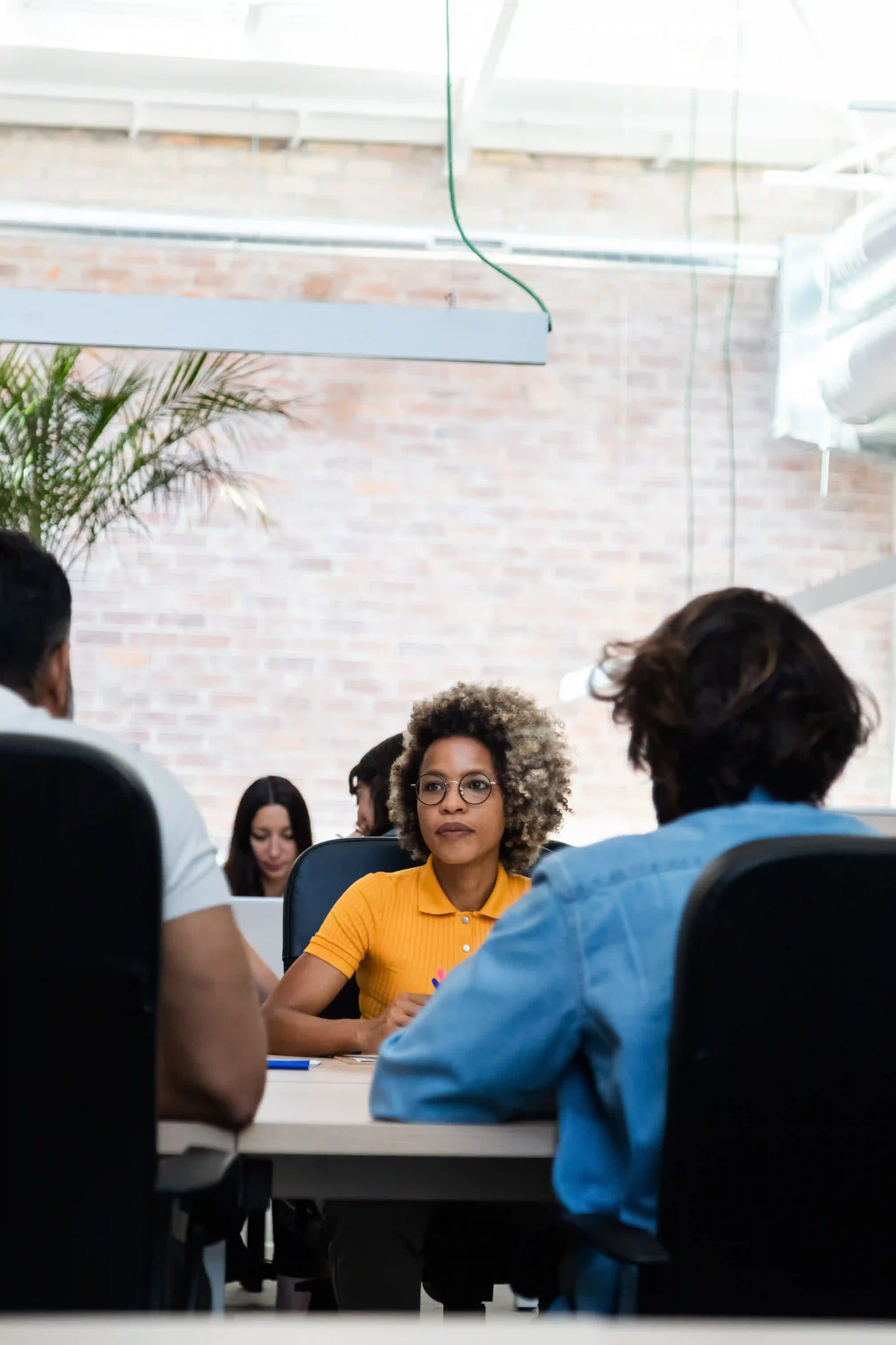 Woman in an office working among other coworkers.