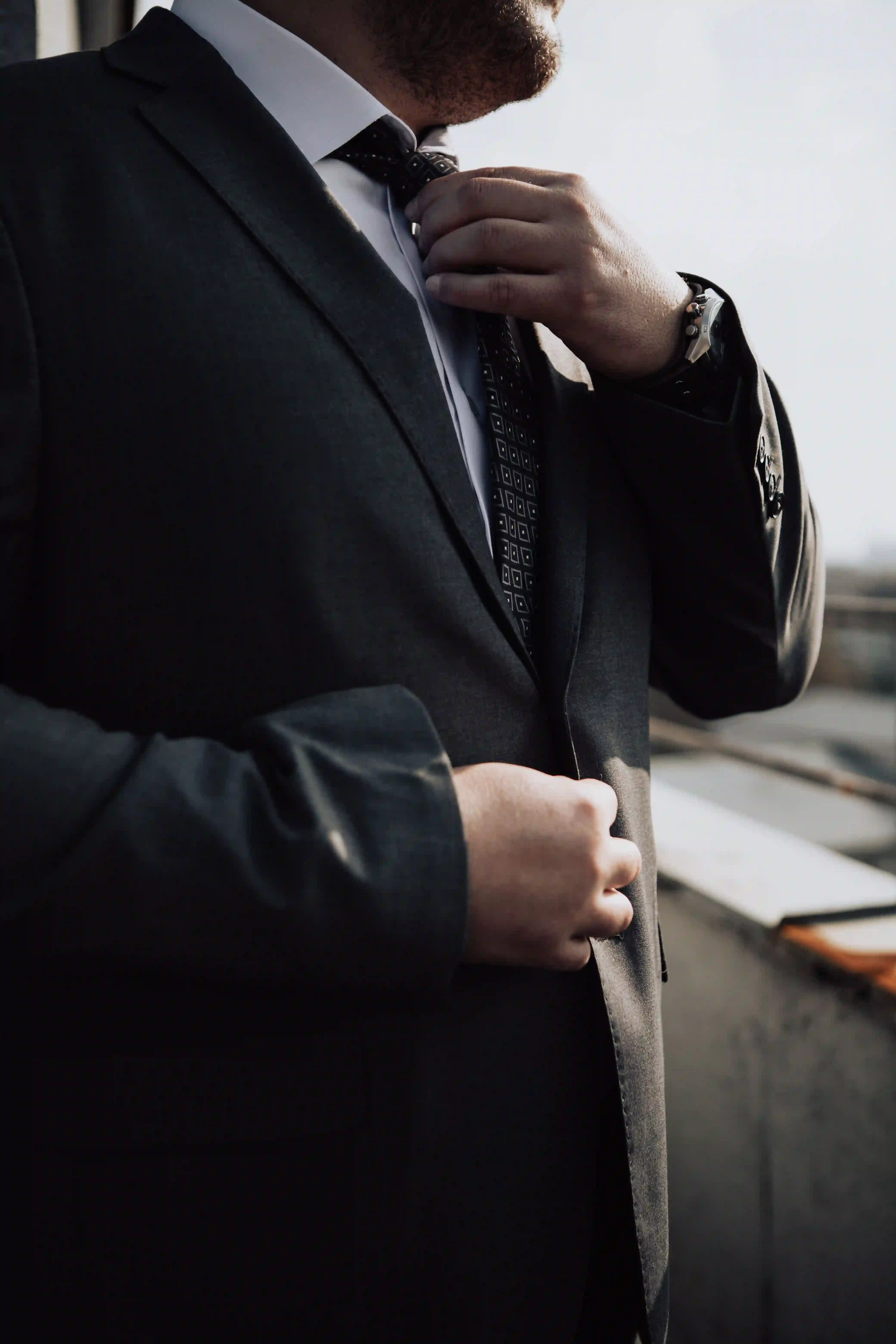 A man adjusting his suit.