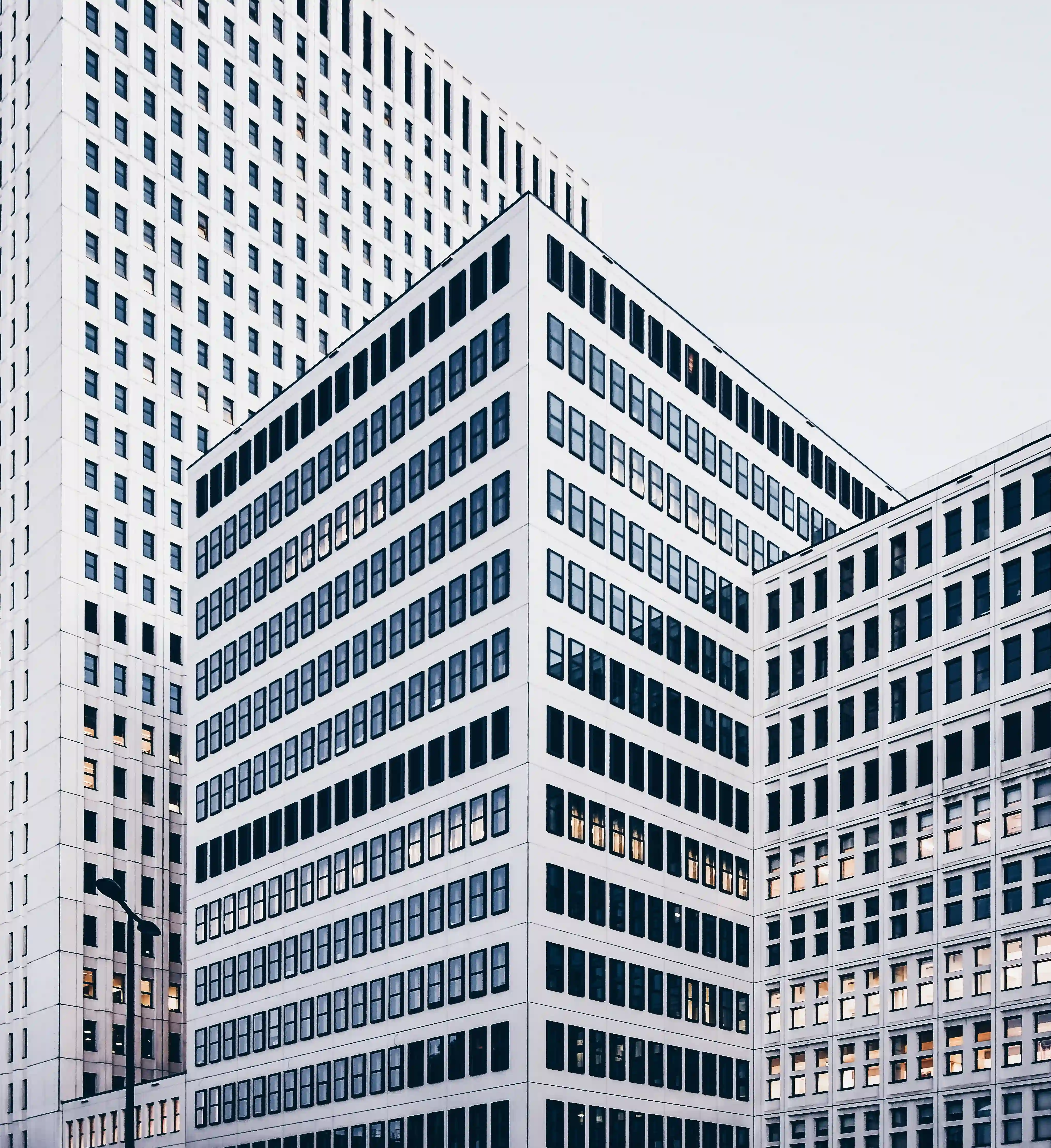 Three white buildings from different sizes.