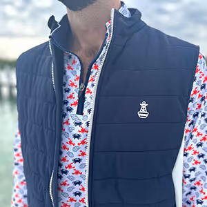 Close-up front detail of the Six Knots Every Day Performance Vest showcasing its rich navy color and signature Six Knots buoy logo. This lightweight, breathable men's performance vest features a stylish navy and cream design, offering versatile layering and all-day comfort. Perfect for boating, fishing, outdoor adventures, and everyday coastal lifestyle wear.