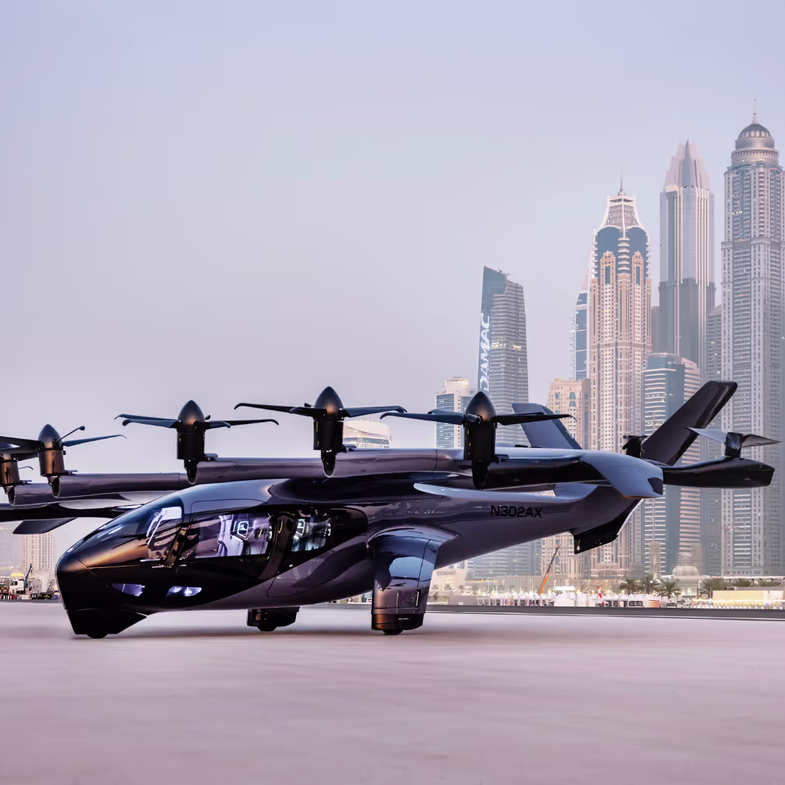 Futuristic electric vertical takeoff and landing (eVTOL) aircraft parked with a city skyline in the background, representing next-generation urban mobility.