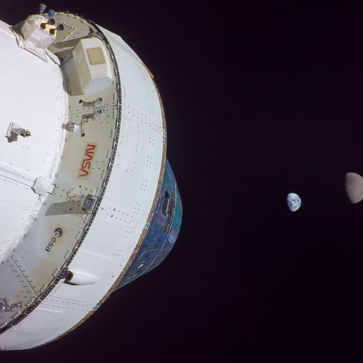 NASA’s Orion spacecraft orbiting the Moon, with a distant view of both the Earth and Moon captured in the background.
