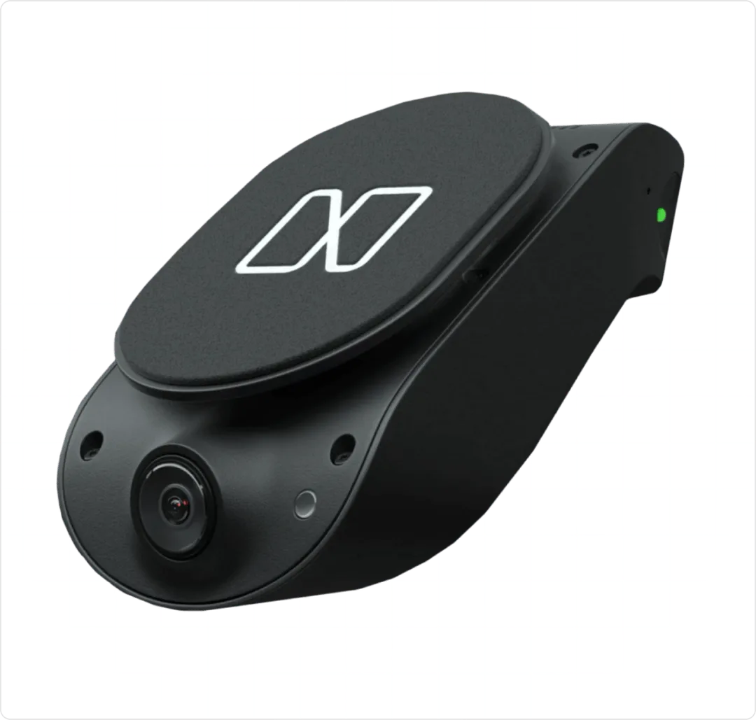 The connected dash camera, angled to show its road-facing lens and the Nauto mark on its housing.
