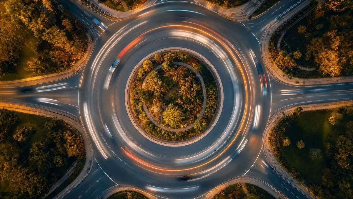 Generated scene: a roundabout from directly above, light trails circling