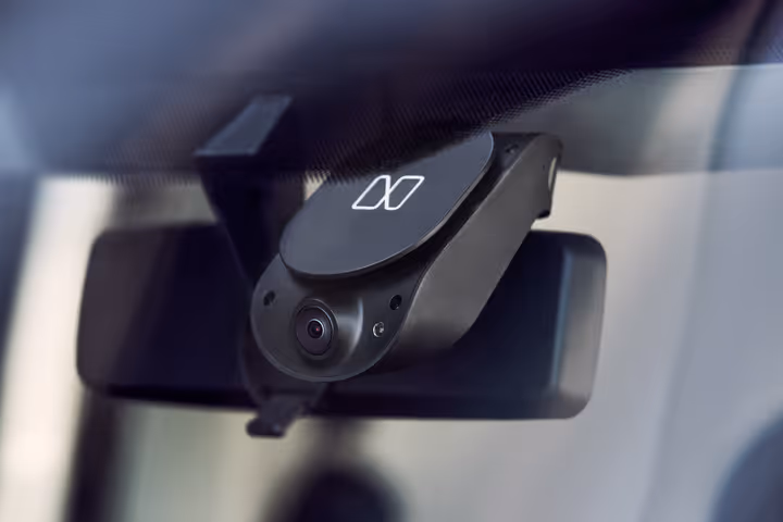 Nauto device mounted on a windshield, viewed from inside the vehicle