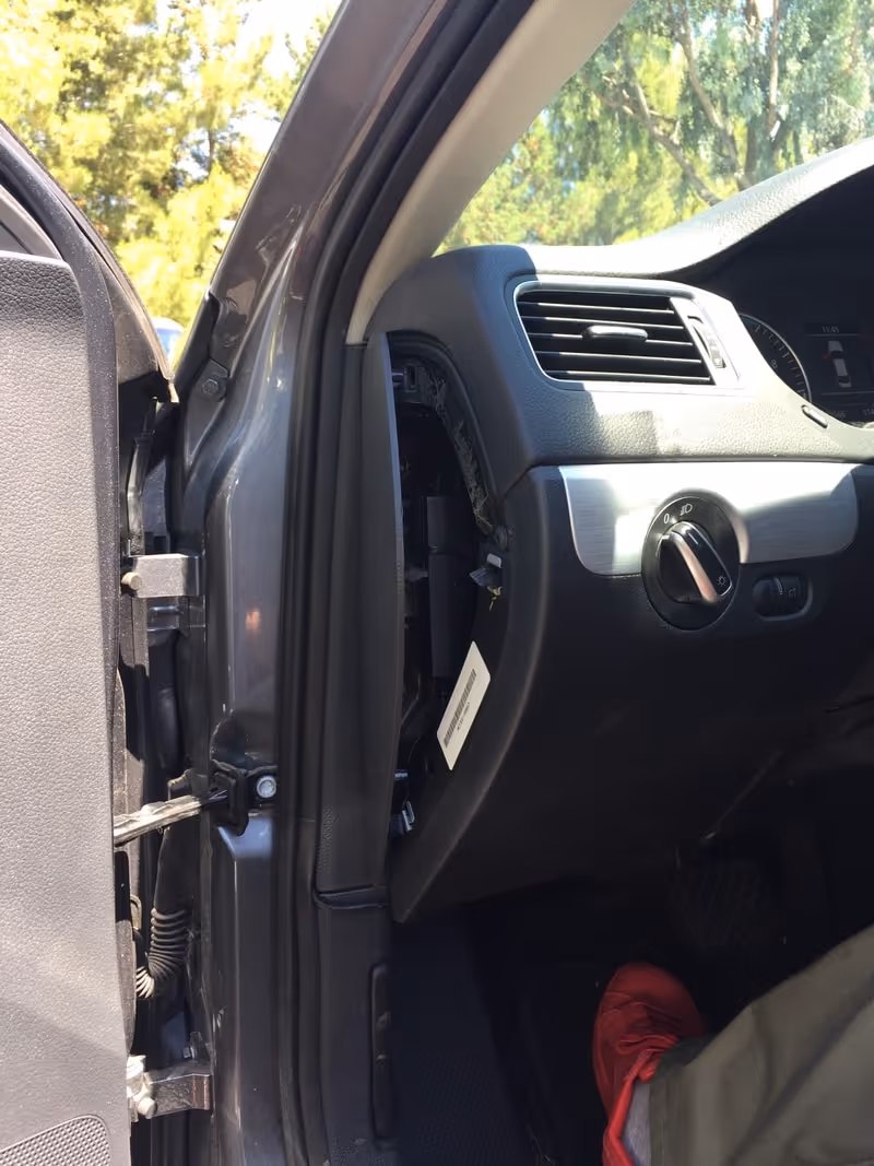 Compartment to the left of the steering wheel, opened with a spudger