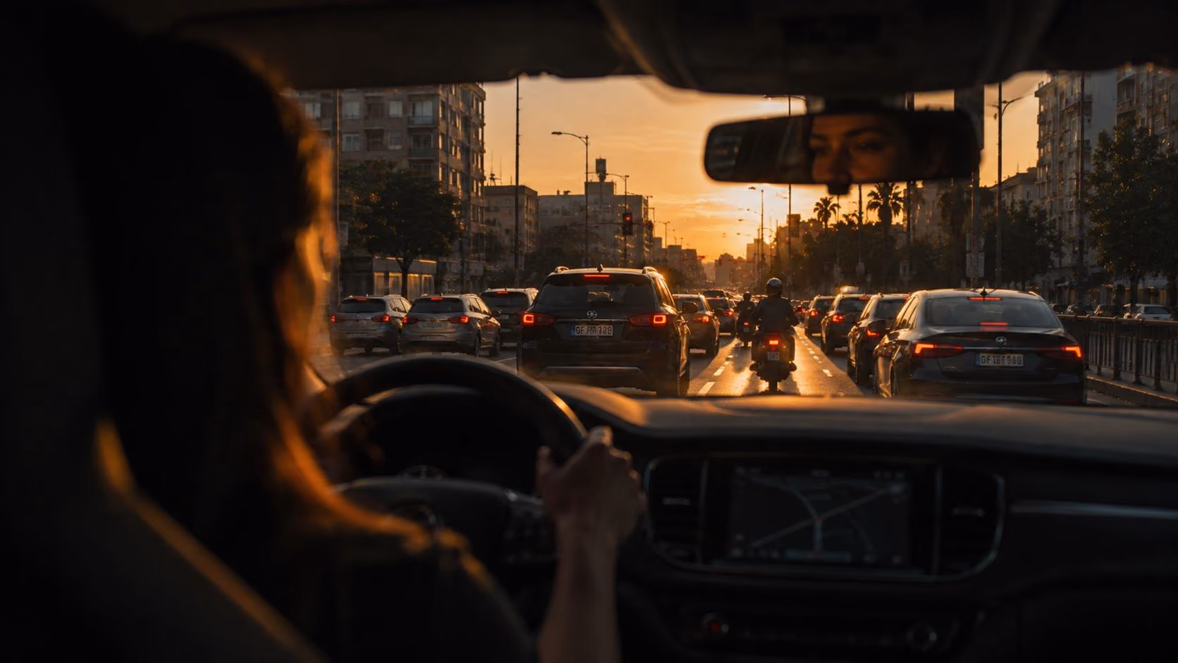 City traffic at sunset seen from the driver's seat