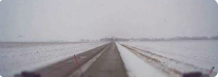 Snowplow dash cam view of a mostly clear road with some snow remaining