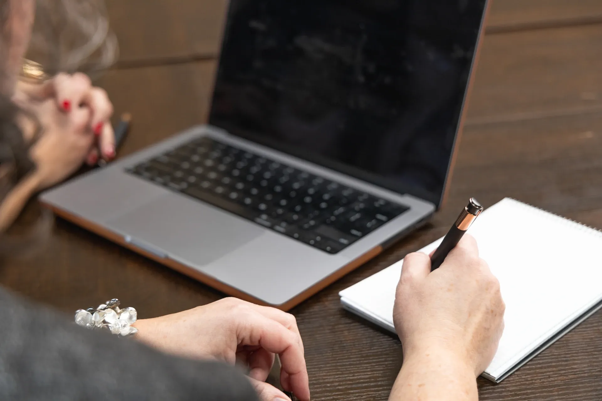 payroll bookkeeping with laptop writing on paper