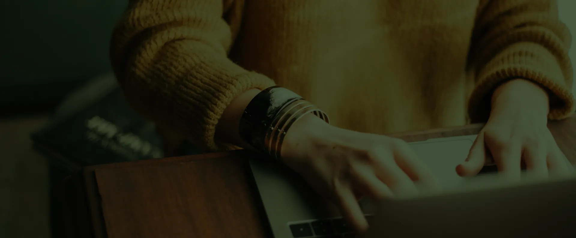 woman on laptop keeping tax compliant green overlay