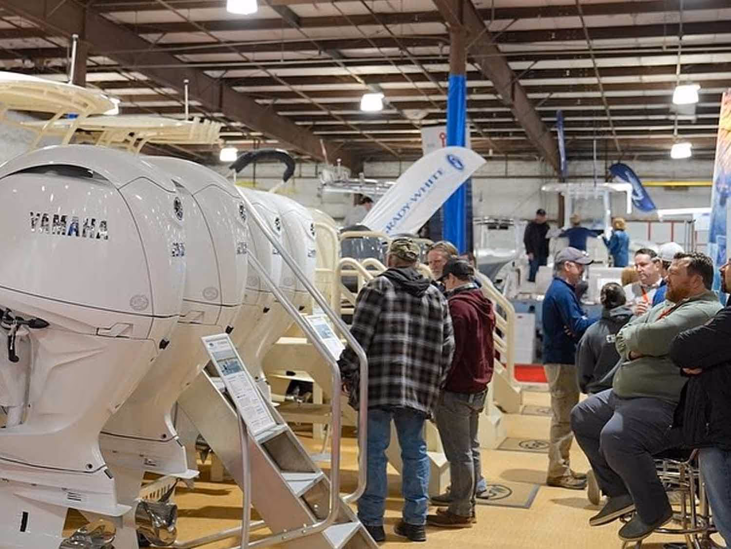 Attendees examining boats on display at the Chesapeake Bay Boat Show in Maryland
