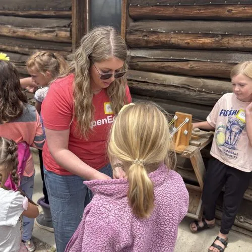adult helping young child 