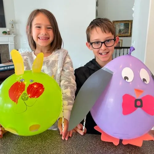 two girls with balloon crafts