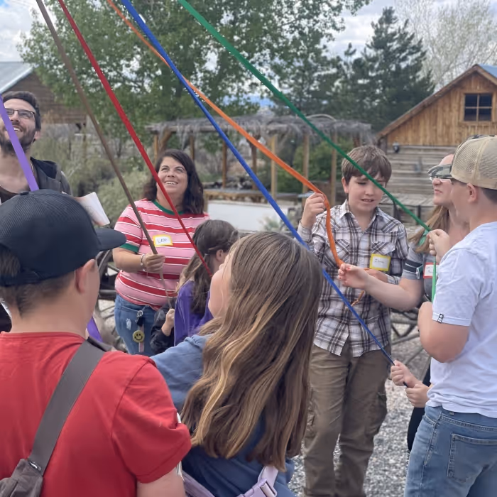 Group of children and adults with colorful ribbon. 
