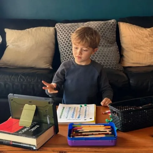 Young boy with a worksheet. 