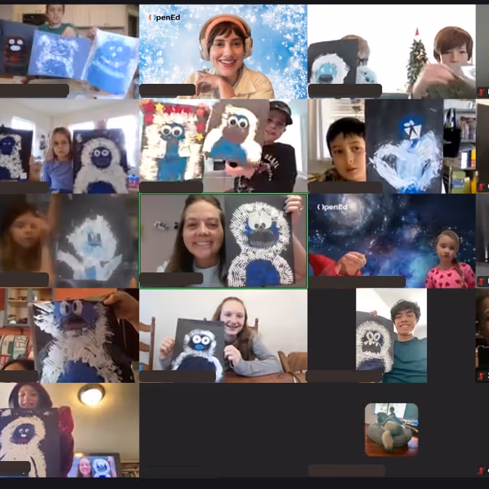 Zoom workshop holding up crafts. 