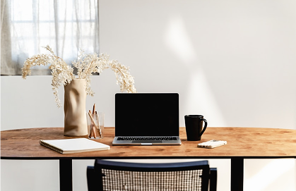 A clean desk with a laptop and coffee mug