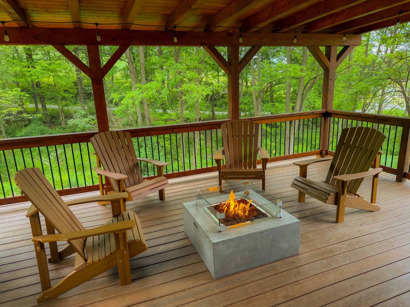 Adirondack chairs around the natural gas fire pit on The Oaks deck