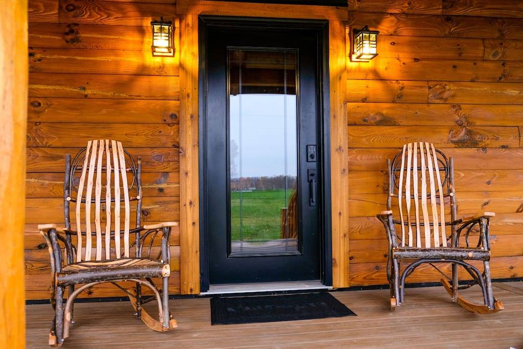 Front porch entrance with hickory rocking chairs at Deer Creek Cabin
