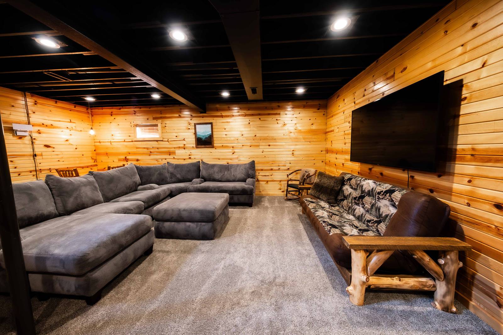 Basement movie night and hangout area with a 70-inch smart TV