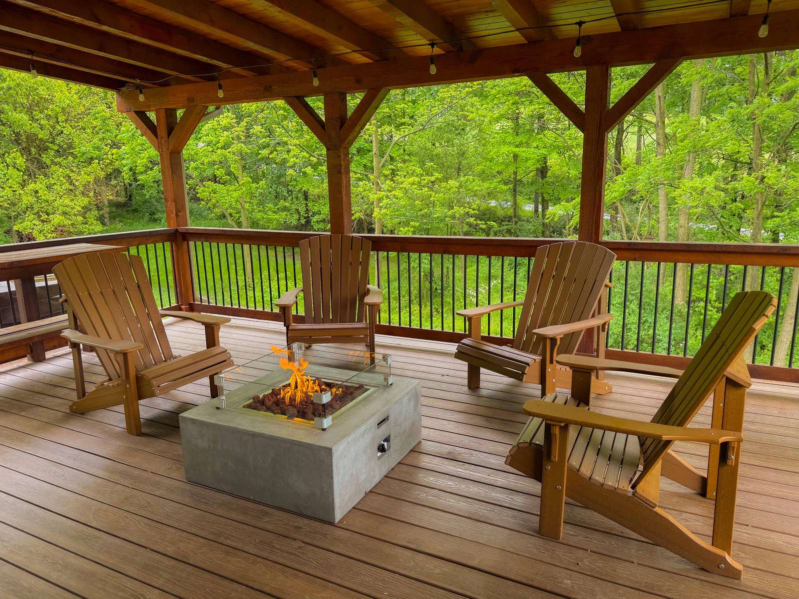 Covered deck with Adirondack chairs and fire pit
