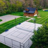 Aerial view of the 50x80 multi-sport court beside Deer Creek Cabin