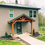 The Oaks, a renovated 1920 farmhouse with a covered entry, in Dundee, Ohio