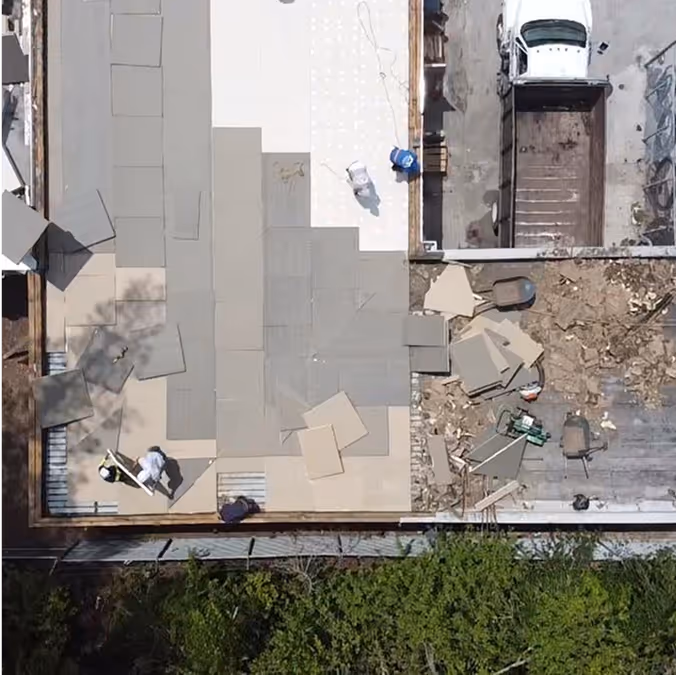 aerial view of a roof replacement in progress  on a commercial building