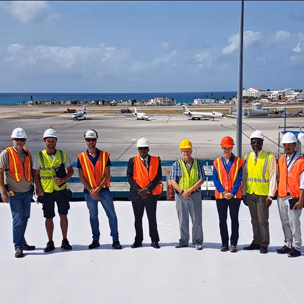 airport staff standing on newly repaired rooftop