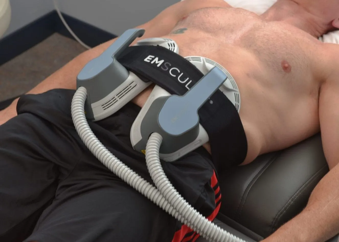 A man getting Emsculpt Neo done