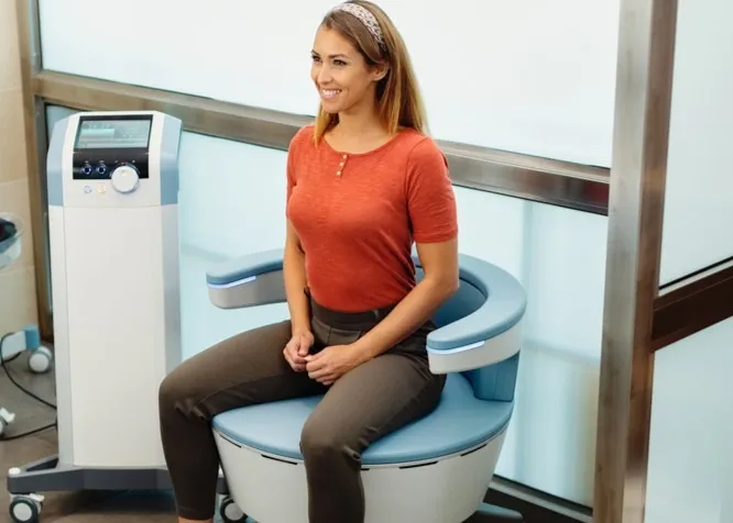 A woman using the Emsella chair.
