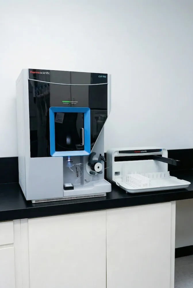 Thermo Scientific iCAP PRO laboratory instrument with connected glass sample vials and a black countertop.