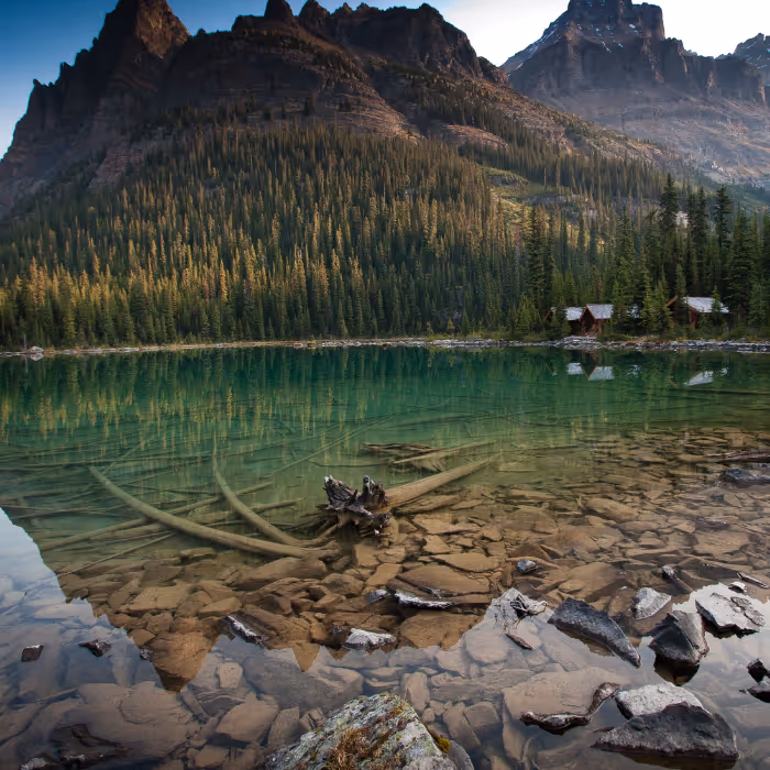Lake O'Hara, alpine lake, with the mountains reflecting off of the water.