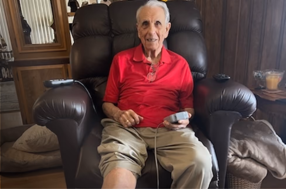 Carlo P. smiling in a recliner at home during his Dayspring treatment