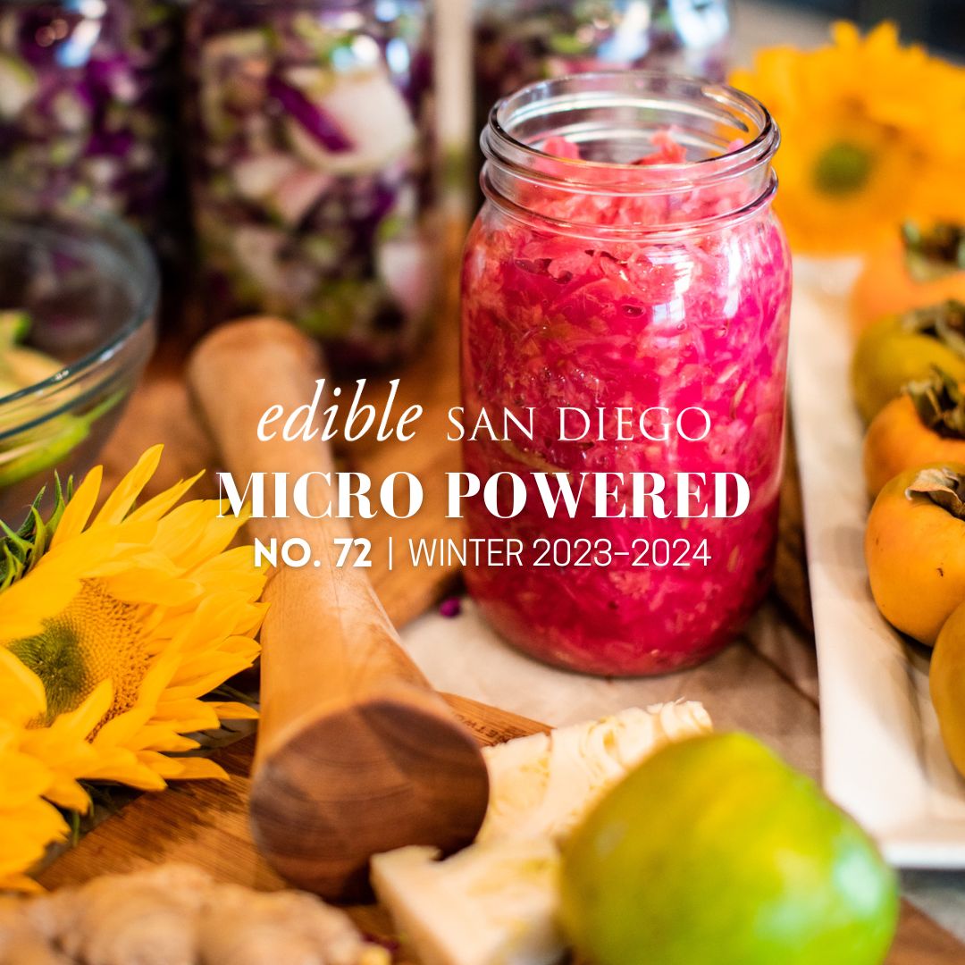 Jars of apple-ginger sauerkraut surrounded by golden sunflowers and persimmons. Photo by Becka Vance for Edible San Diego.