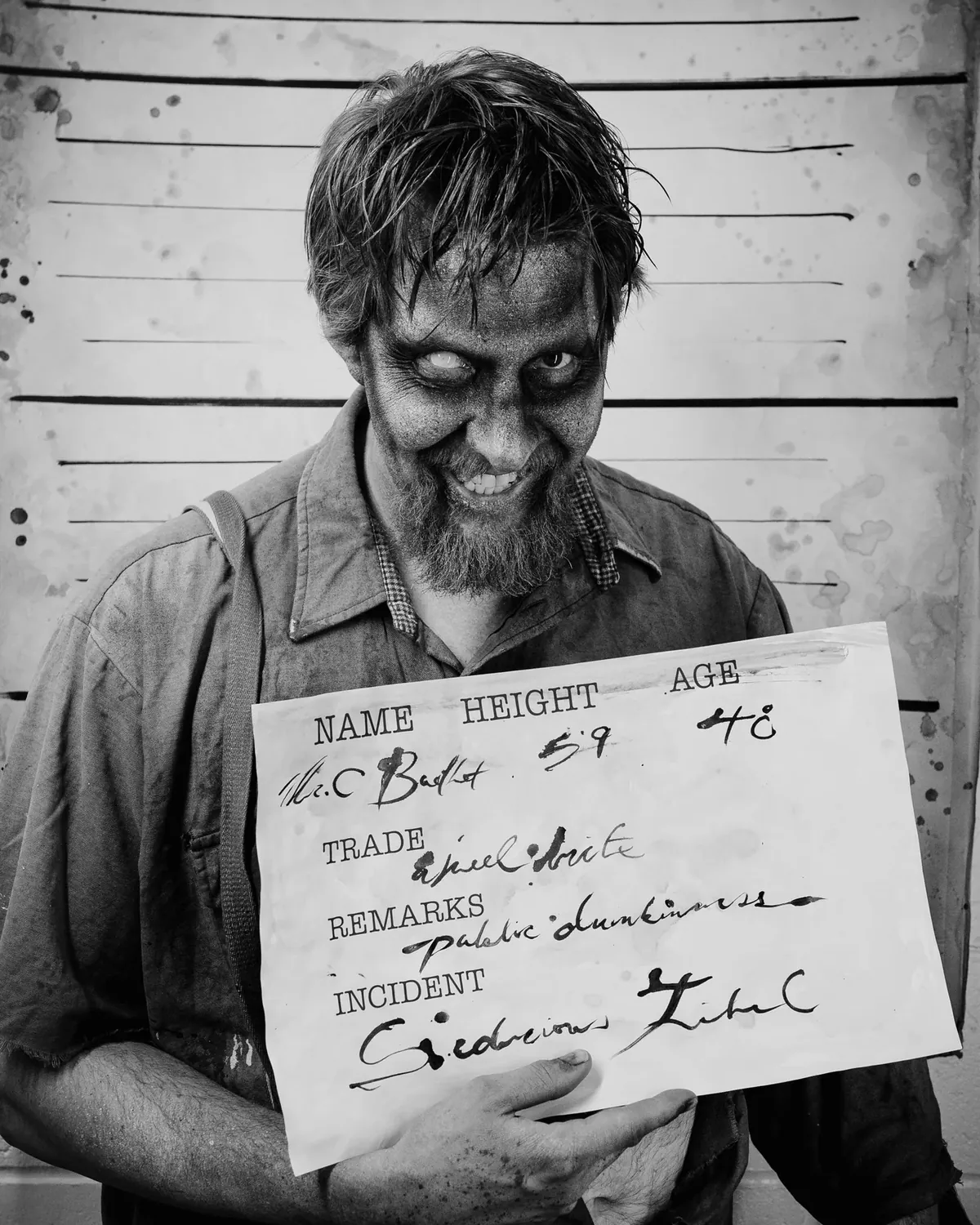 A grinning inmate holding an identification slate in a black-and-white Dark Prison mugshot.