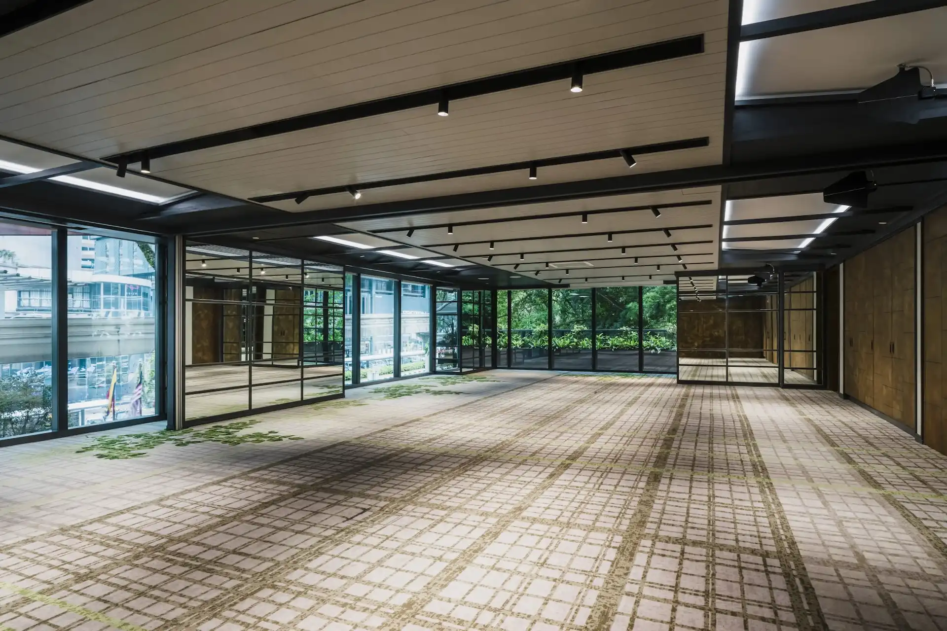 Level 1 function space at Hyatt Centric City Centre Kuala Lumpur, with full-height glazing and views out to the surrounding tree canopy