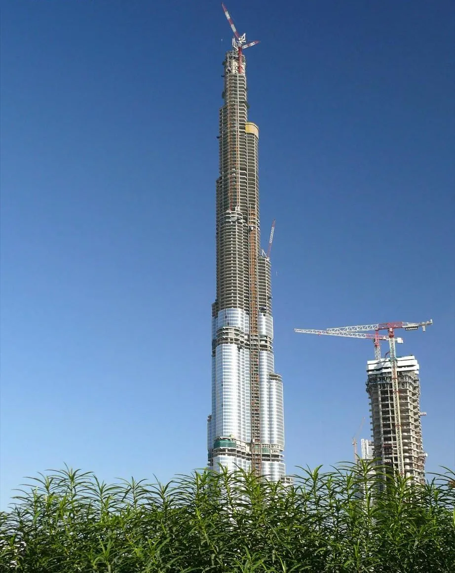 Burj Dubai under construction with cranes on its upper floors
