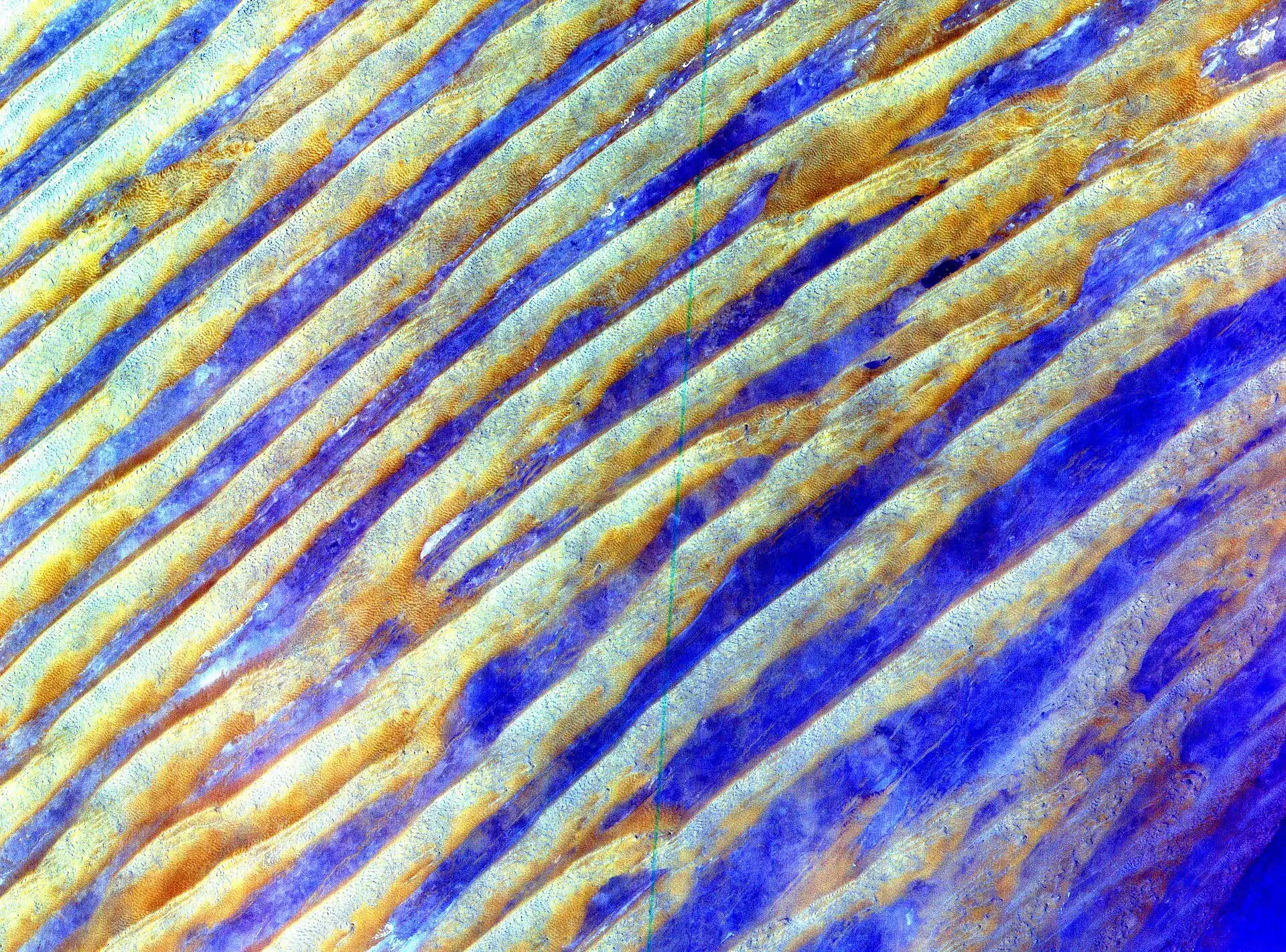 Satellite view of parallel linear sand dunes in the Rub' al Khali, Saudi Arabia