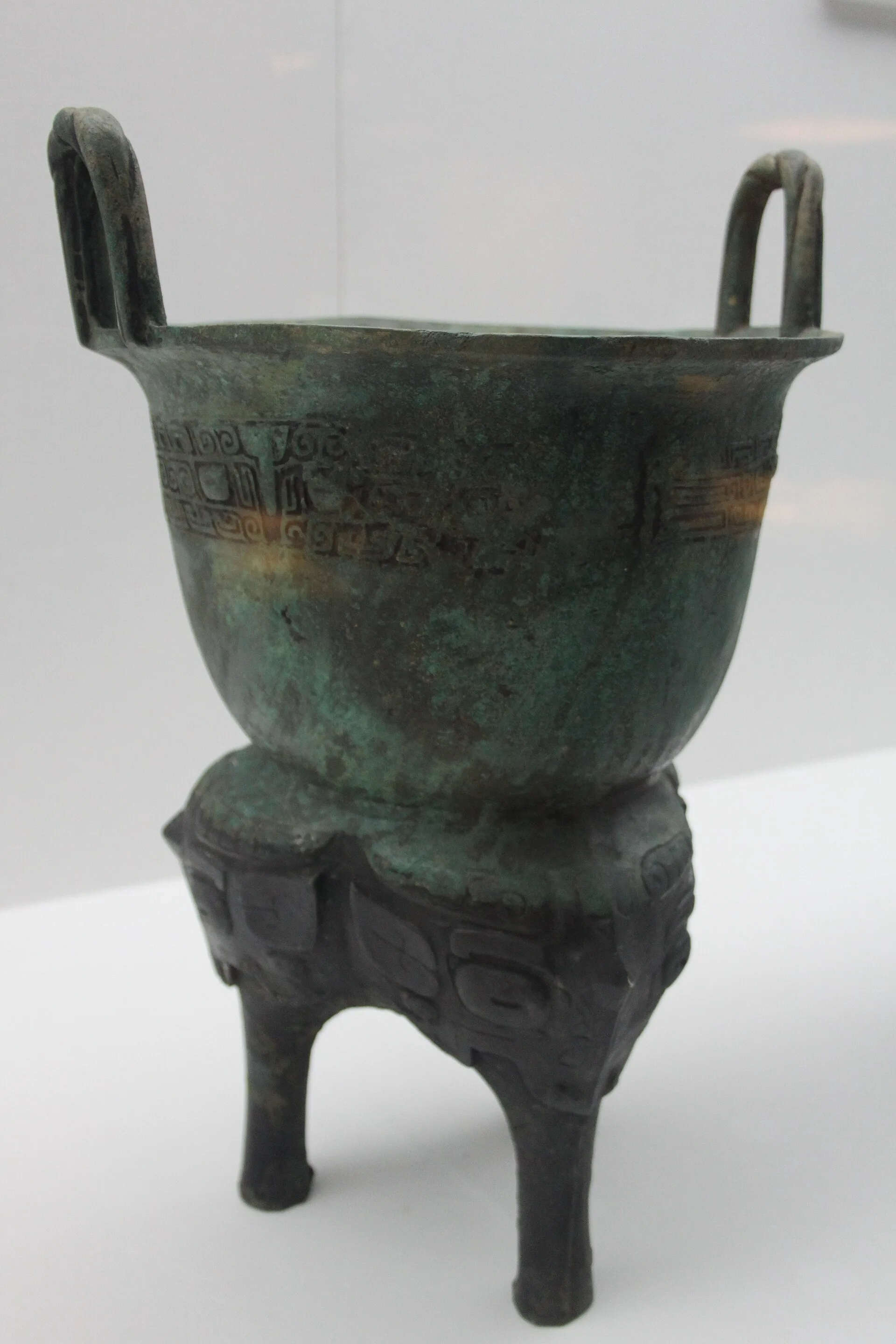 Ancient Chinese bronze yan steamer on display in a museum