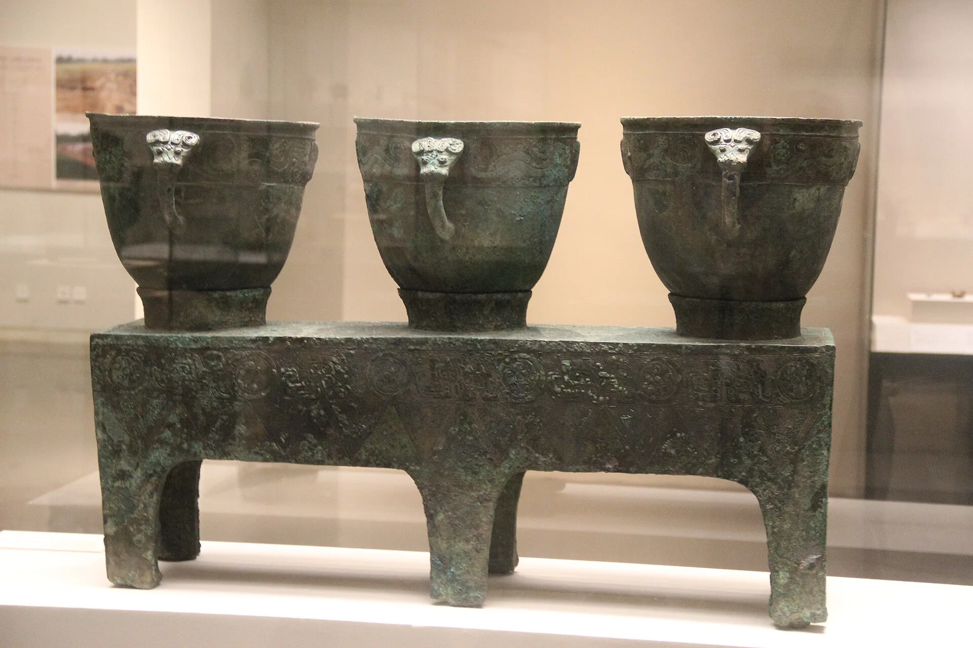 Shang dynasty bronze triple steamer with three vessels on one base