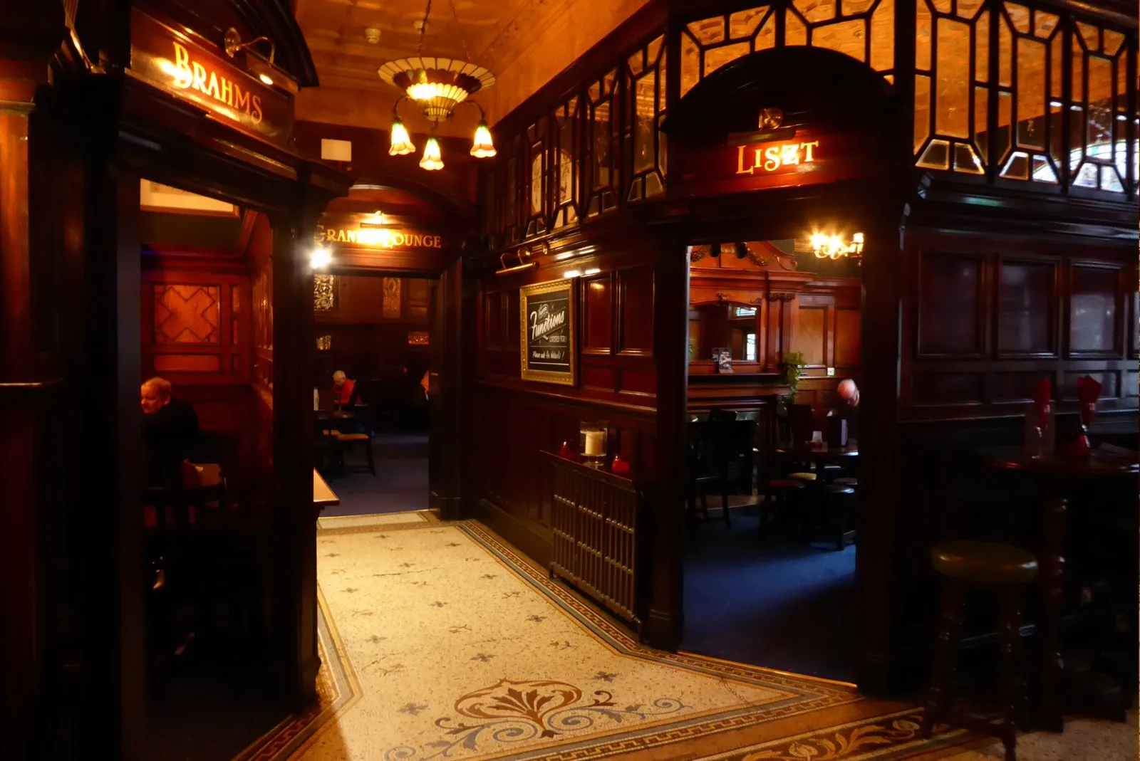 Dark timber panelled interior with mosaic floor at the Philharmonic Dining Rooms in Liverpool